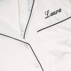 White satin pyjama top with personalised embroidery.